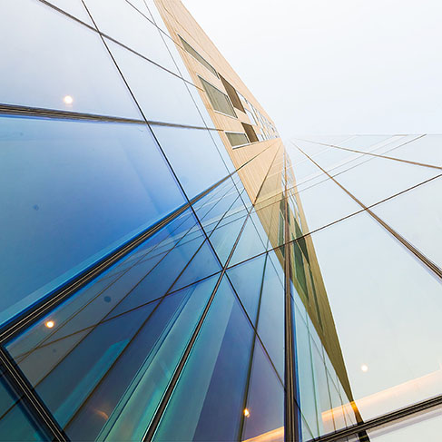 Glass modern building against bright sky